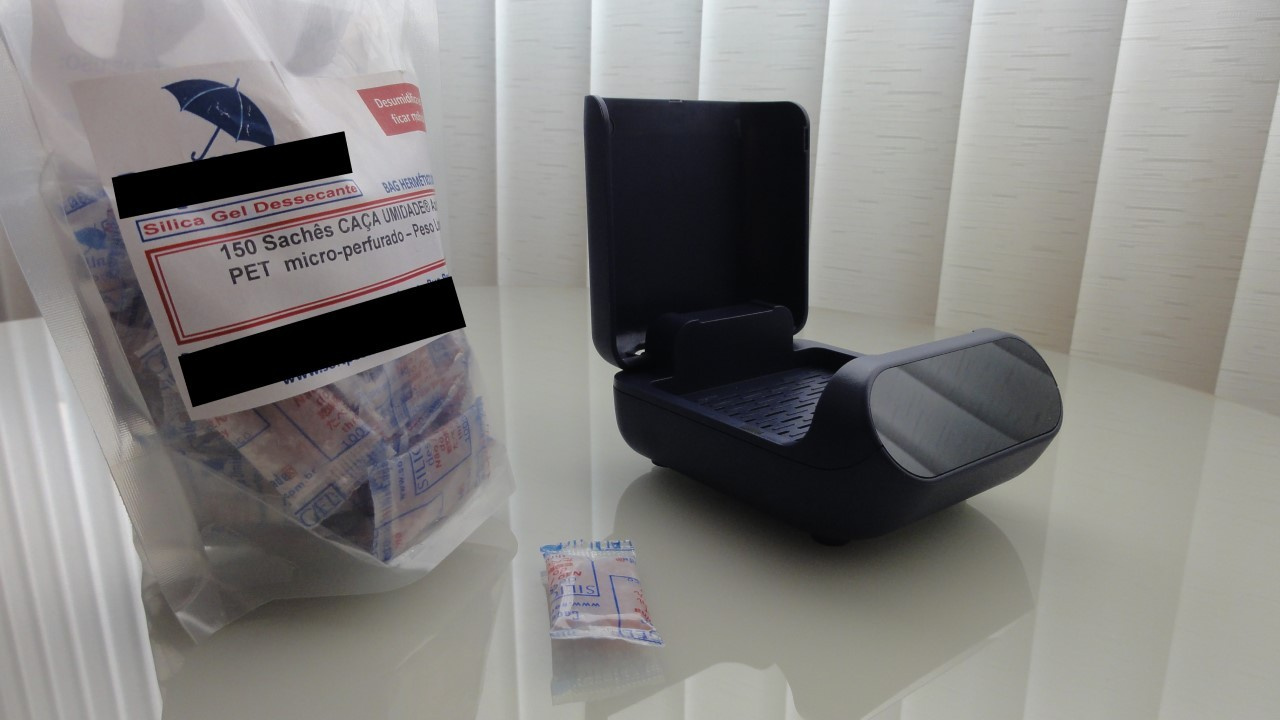 Package with silica gel packets and an electric hearing aid dehumidifier.