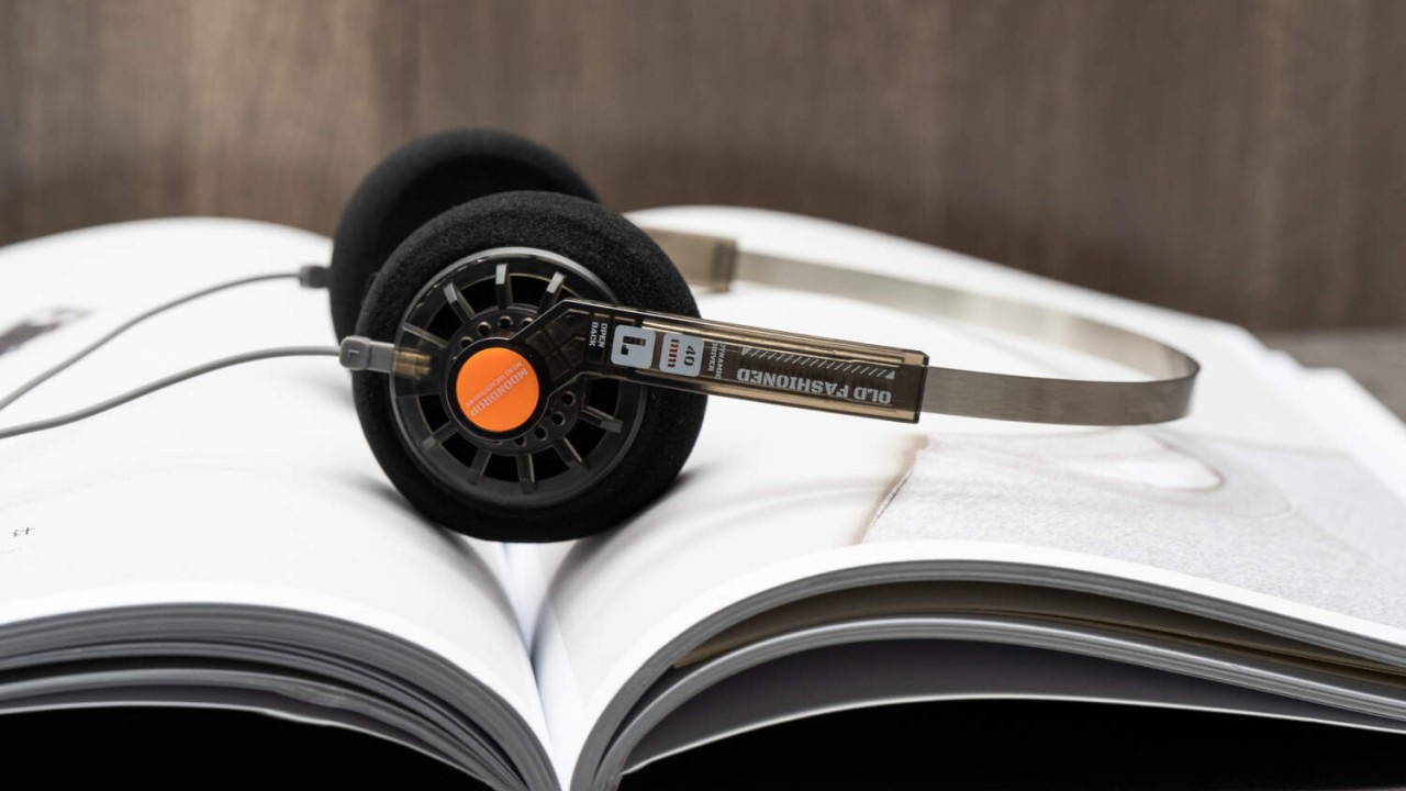 Headphone Moondrop Old Fashion sobre um livro.